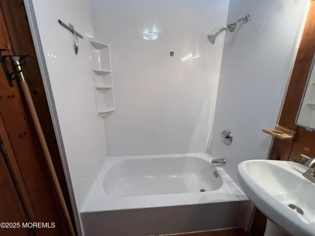 a bathroom with a tub sink and toilet