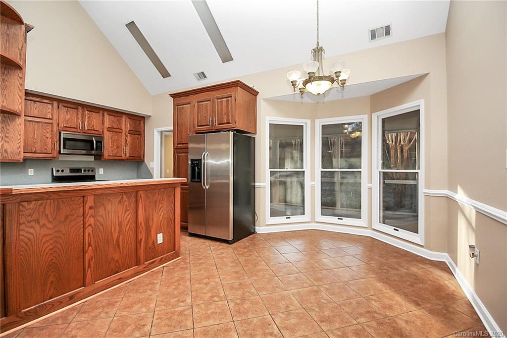 1465 Deer Run Road, Unit 3 Catawba, SC 29704 - Photo 23 of 31 a view of a kitchen with granite countertop stainless steel appliances and a chandelier