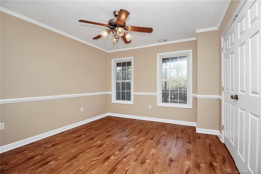 1465 Deer Run Road, Unit 3 Catawba, SC 29704 - Photo 8 of 31 a view of an empty room with wooden floor and a window
