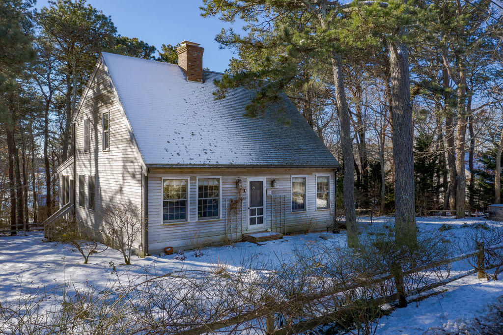 95 Cannon Hill Road Wellfleet, MA 02667 - Photo 1 of 36 a front view of a house with garden