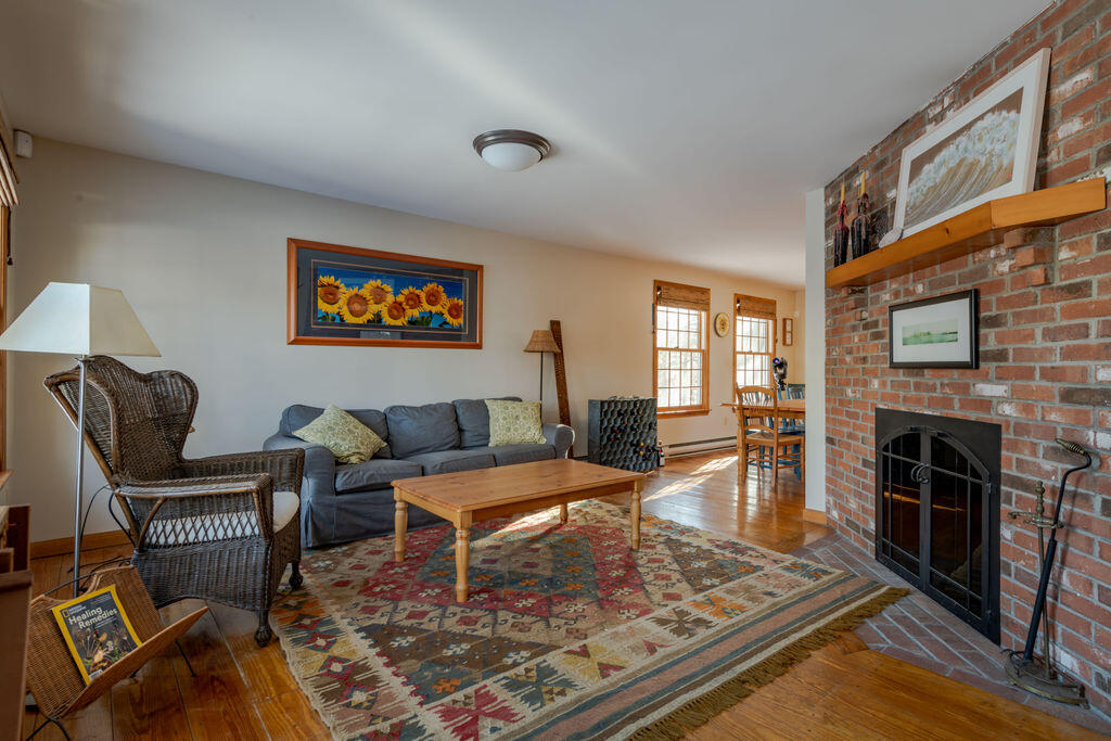 95 Cannon Hill Road Wellfleet, MA 02667 - Photo 11 of 36 a living room with furniture and a fireplace