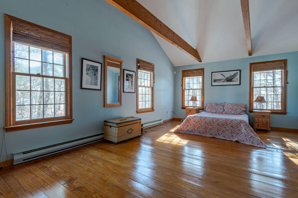 95 Cannon Hill Road Wellfleet, MA 02667 - Photo 15 of 36 a spacious bedroom with a bed and wooden floor