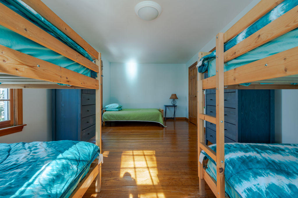95 Cannon Hill Road Wellfleet, MA 02667 - Photo 16 of 36 a bedroom with a bed and a dresser next to a window
