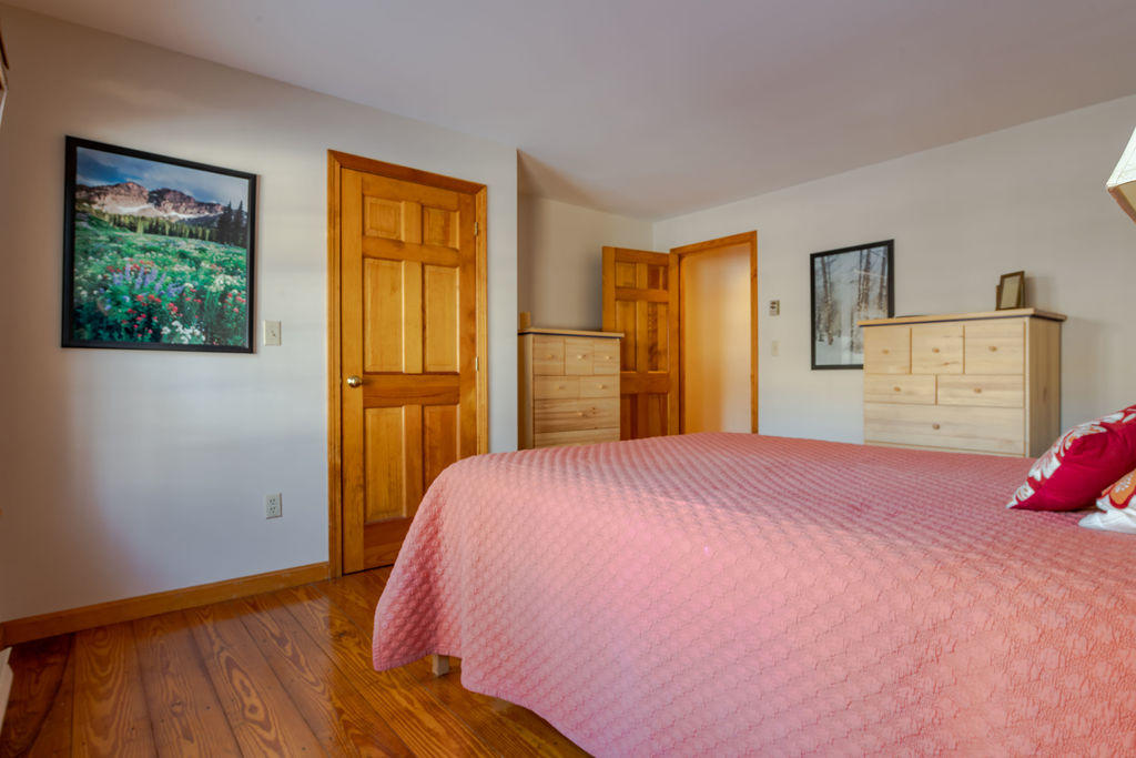 95 Cannon Hill Road Wellfleet, MA 02667 - Photo 19 of 36 a bedroom with a bed and wooden floor