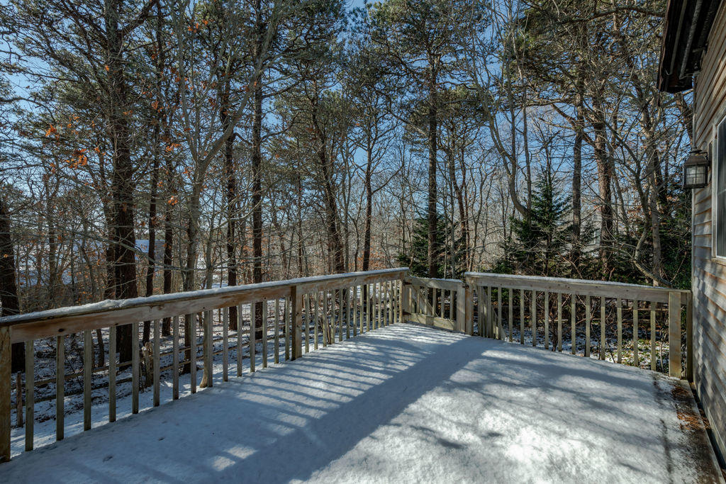 95 Cannon Hill Road Wellfleet, MA 02667 - Photo 26 of 36 a view of a balcony with wooden floor and fence