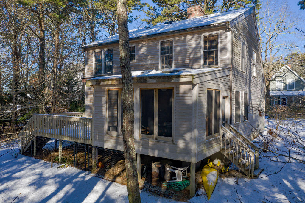 95 Cannon Hill Road Wellfleet, MA 02667 - Photo 28 of 36 a front view of a house with a yard