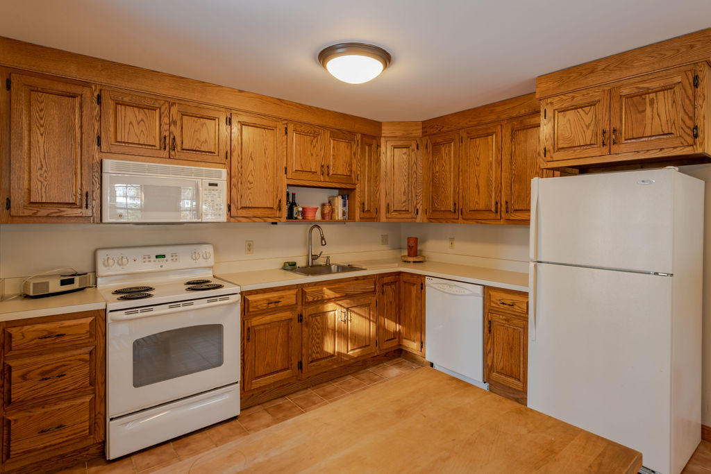 95 Cannon Hill Road Wellfleet, MA 02667 - Photo 5 of 36 a kitchen with a stove cabinets and a refrigerator