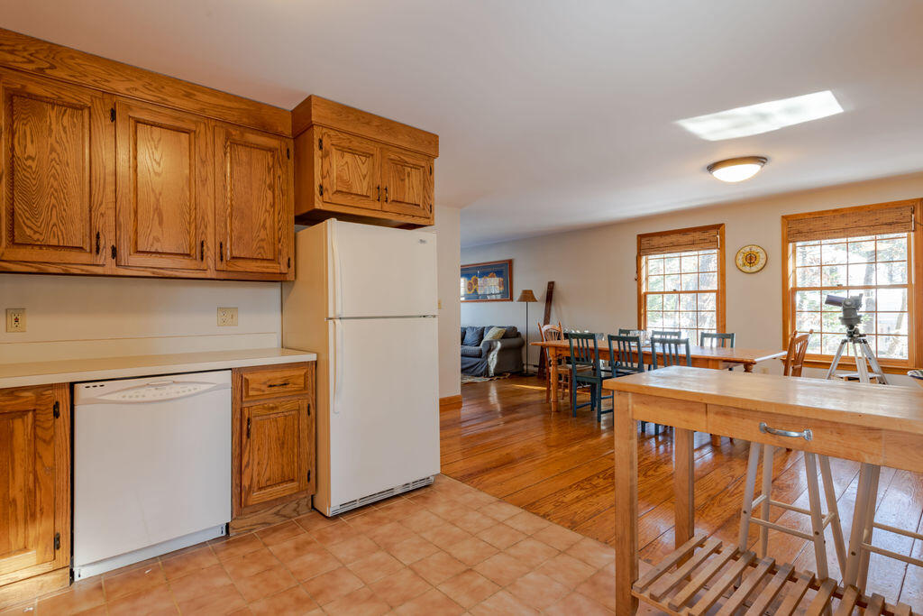 95 Cannon Hill Road Wellfleet, MA 02667 - Photo 6 of 36 a kitchen with refrigerator and cabinets