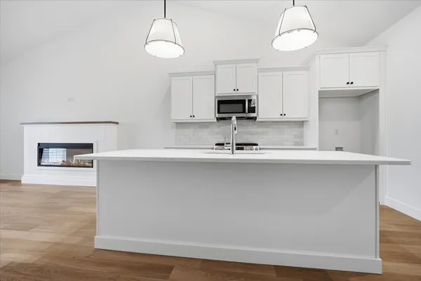 a kitchen with stainless steel appliances a sink a stove and a refrigerator
