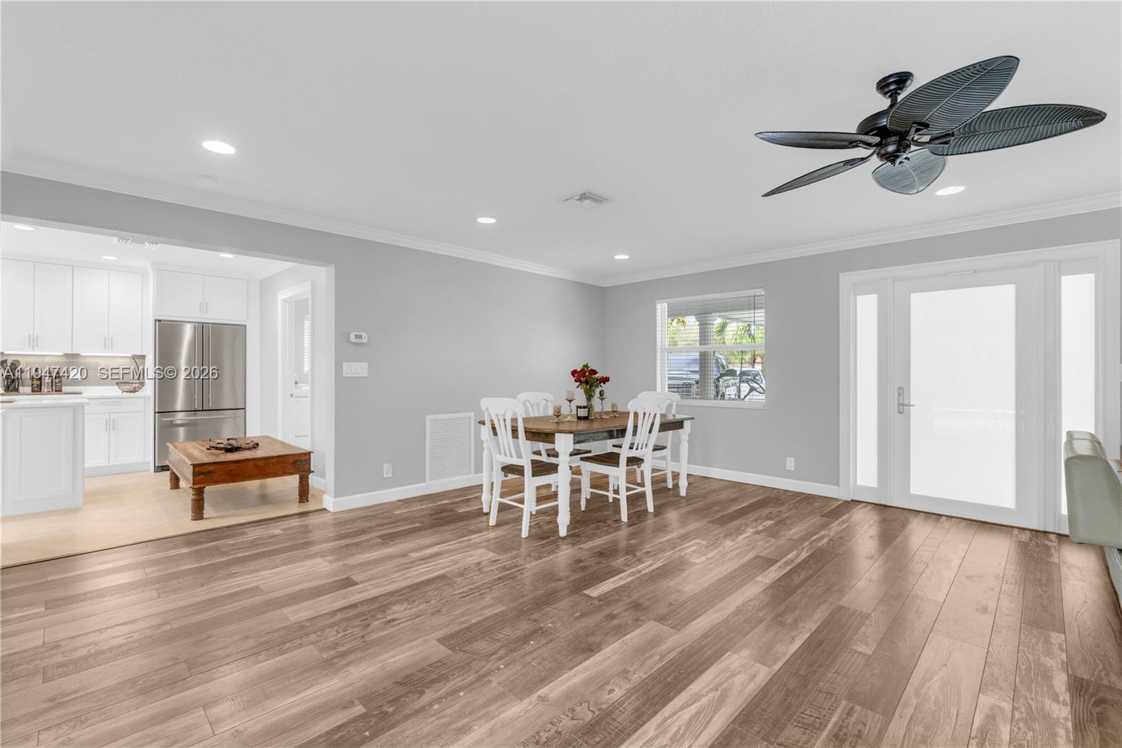 1405 Southwest 4th Terrace Pompano Beach, FL 33060 - Photo 12 of 44 a dining room with wooden floor and a window