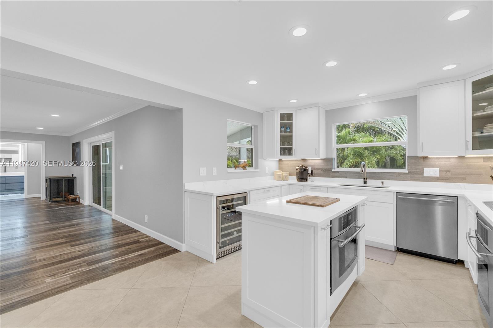 1405 Southwest 4th Terrace Pompano Beach, FL 33060 - Photo 14 of 44 a kitchen with a sink stove and cabinets