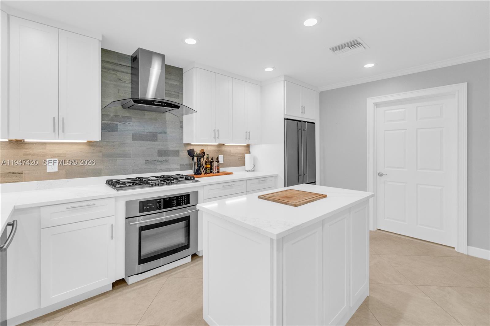 1405 Southwest 4th Terrace Pompano Beach, FL 33060 - Photo 15 of 44 a kitchen with a stove and a refrigerator