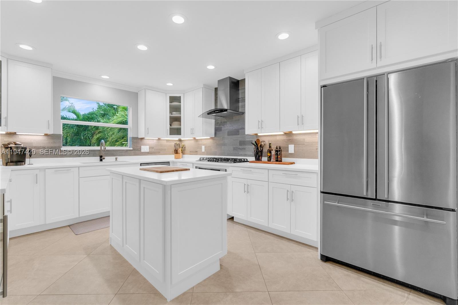 1405 Southwest 4th Terrace Pompano Beach, FL 33060 - Photo 16 of 44 a kitchen with white cabinets and stainless steel appliances