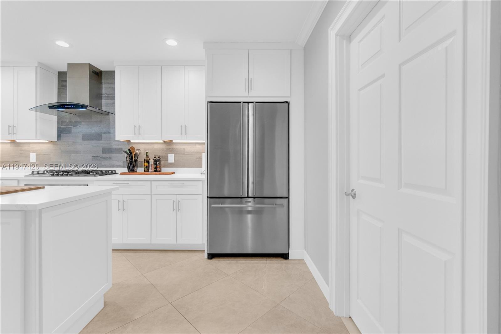 1405 Southwest 4th Terrace Pompano Beach, FL 33060 - Photo 19 of 44 a kitchen with cabinets and stainless steel appliances