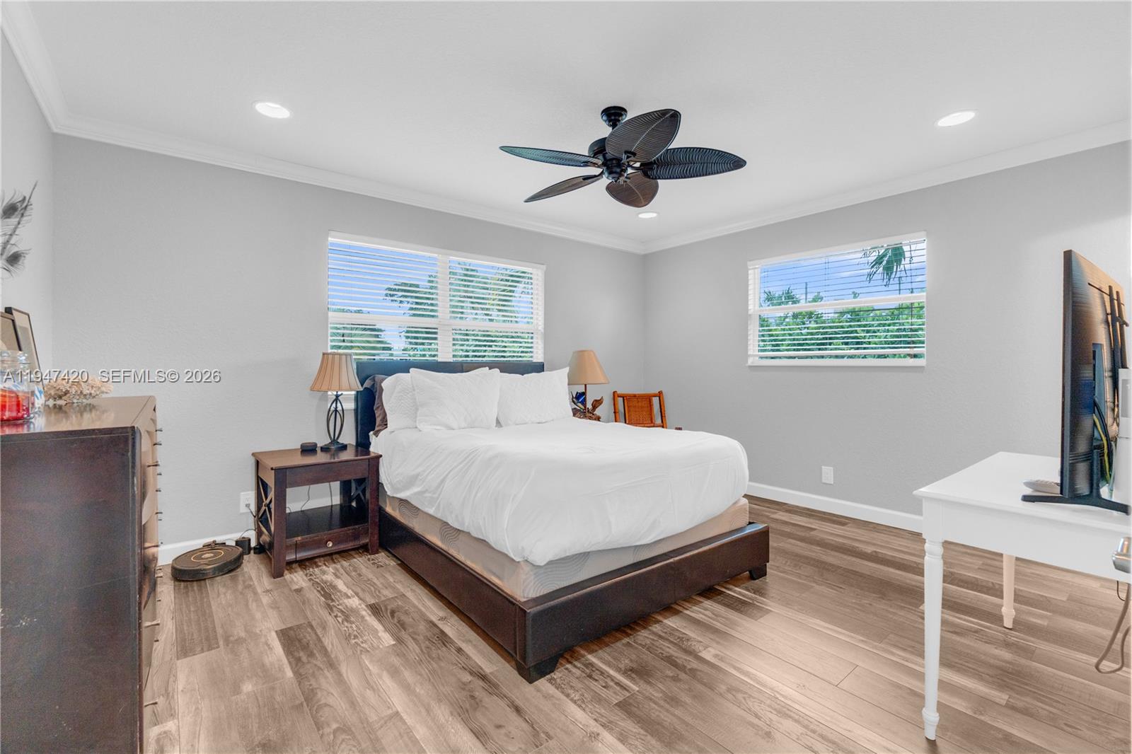 1405 Southwest 4th Terrace Pompano Beach, FL 33060 - Photo 20 of 44 a bedroom with a bed and a flat tv screen on dresser