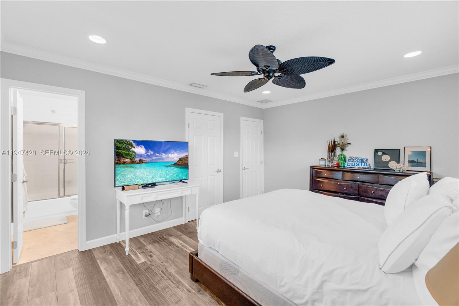 1405 Southwest 4th Terrace Pompano Beach, FL 33060 - Photo 21 of 44 a bedroom with a bed and a flat screen tv