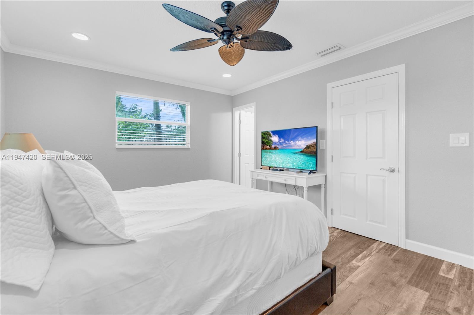 1405 Southwest 4th Terrace Pompano Beach, FL 33060 - Photo 22 of 44 a bedroom with a bed and a flat screen tv