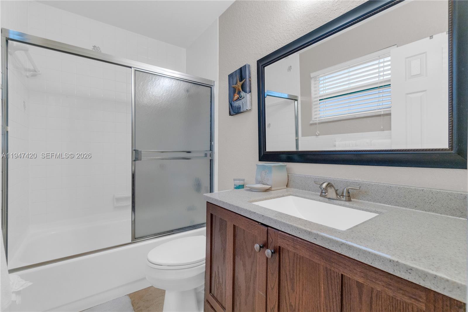1405 Southwest 4th Terrace Pompano Beach, FL 33060 - Photo 23 of 44 a bathroom with a sink a toilet and shower