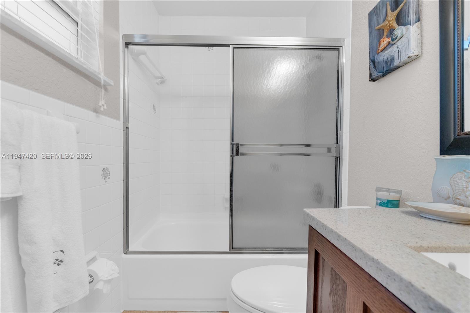 1405 Southwest 4th Terrace Pompano Beach, FL 33060 - Photo 24 of 44 a bathroom with a granite countertop sink toilet and shower
