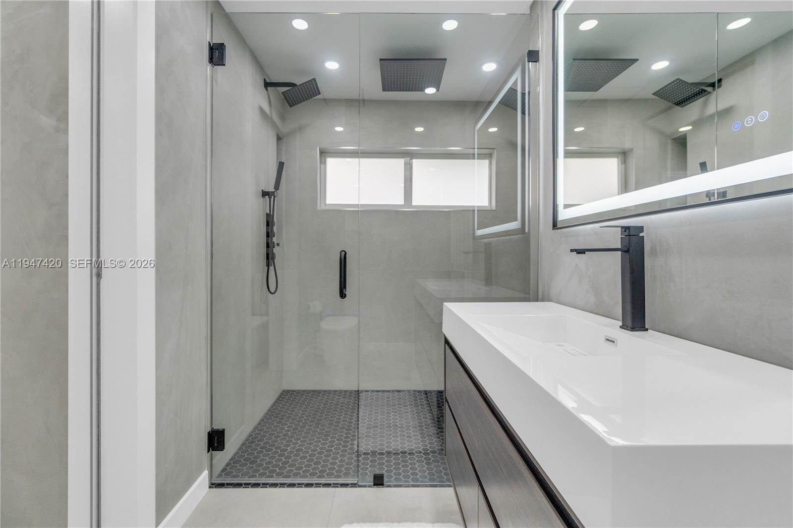 1405 Southwest 4th Terrace Pompano Beach, FL 33060 - Photo 29 of 44 a bathroom with a sink a toilet and shower