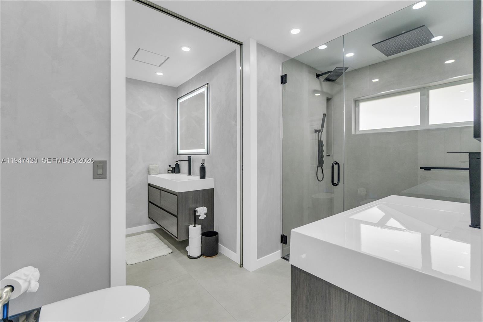 1405 Southwest 4th Terrace Pompano Beach, FL 33060 - Photo 31 of 44 a bathroom with a sink a toilet and shower