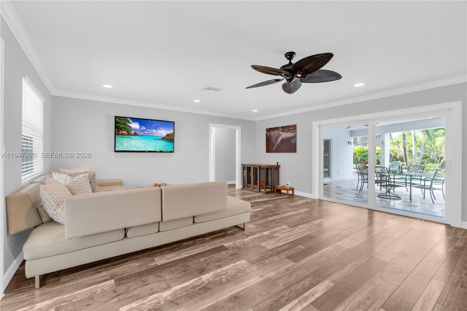 1405 Southwest 4th Terrace Pompano Beach, FL 33060 - Photo 9 of 44 a living room with furniture ceiling fan and a large window