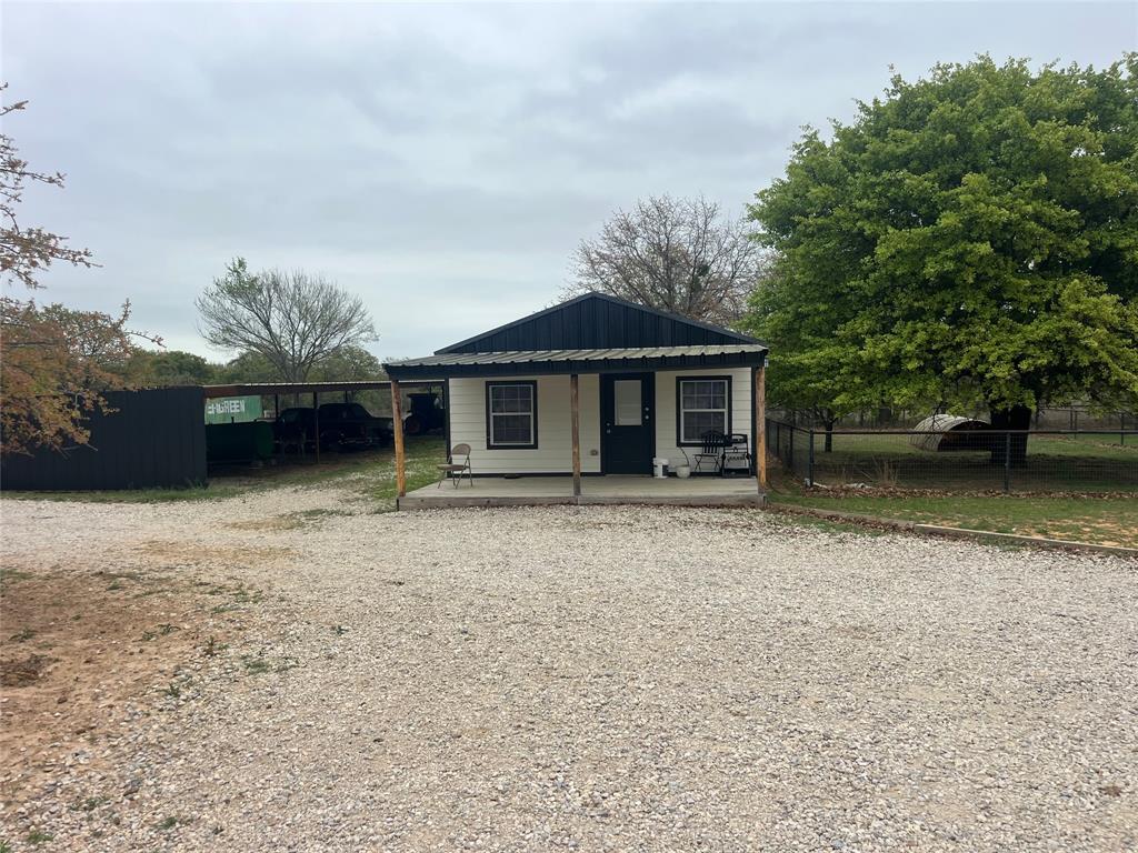 7601 Zion Hill Road Poolville, TX 76487 - Photo 39 of 39 front view of a house with a yard