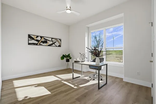 a view of a workspace with wooden floor
