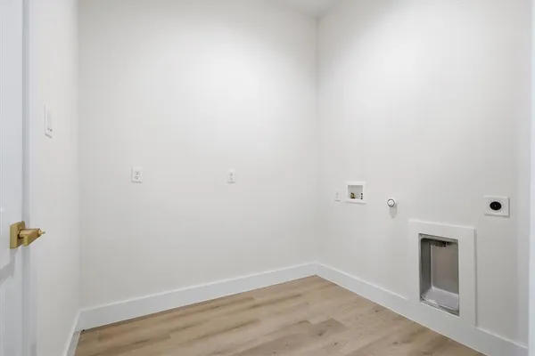 a view of a room with wooden floor and white walls