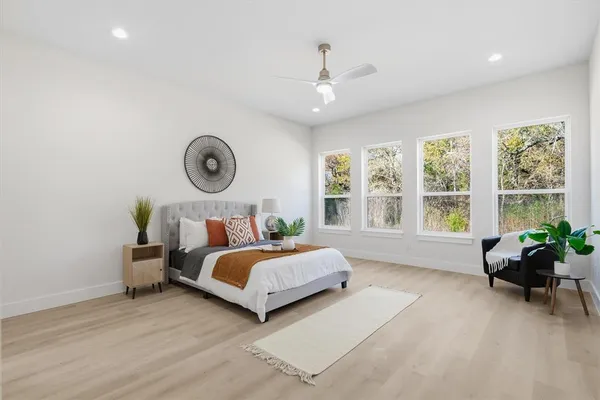 a bedroom with a bed and a large window