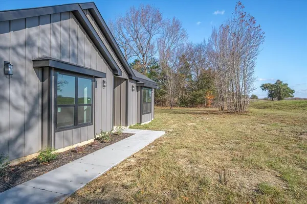 a view of backyard with large trees