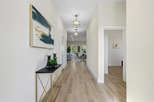 a view of a hallway view with wooden floor and staircase