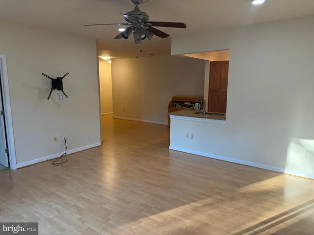 a view of a livingroom with a ceiling fan and hardwood floor