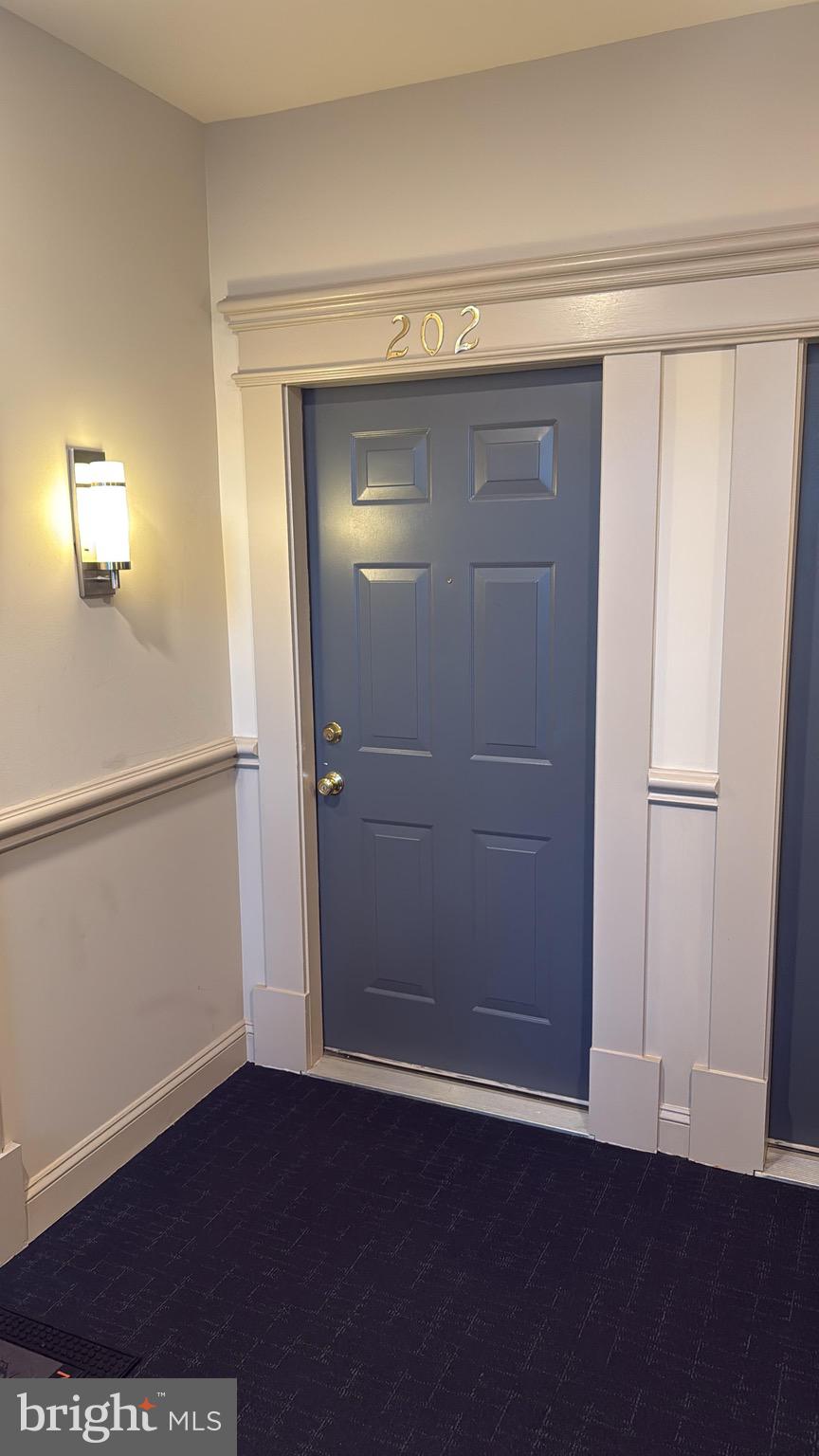 11326 Westbrook Mill Lane, Unit 202 Fairfax, VA 22030 - Photo 2 of 15 an empty room with wooden floor and closet