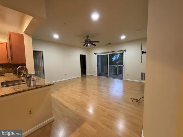 a view of a kitchen with a sink and a large window