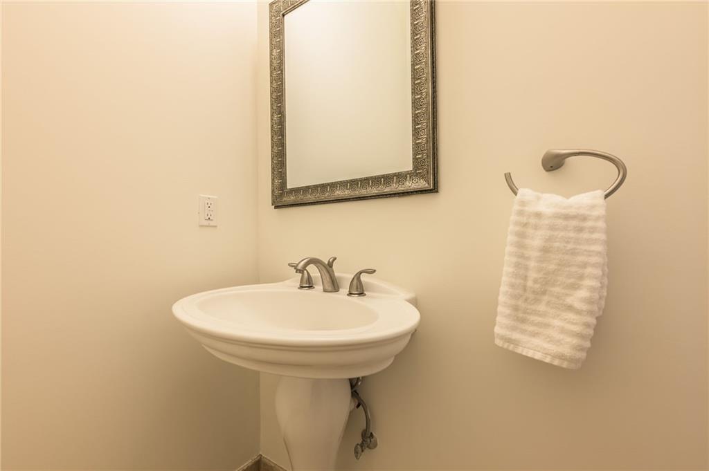 9510 Lisa Circle Gainesville, GA 30506 - Photo 65 of 80 a bathroom with a sink a mirror and a toilet