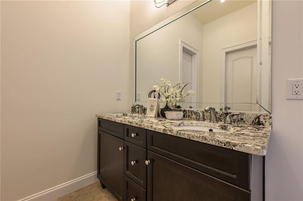 9510 Lisa Circle Gainesville, GA 30506 - Photo 68 of 80 a bathroom with a granite countertop sink and a mirror