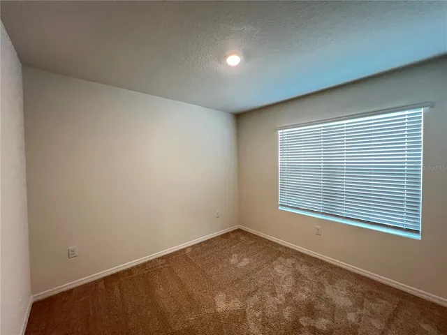 an empty room with closet area