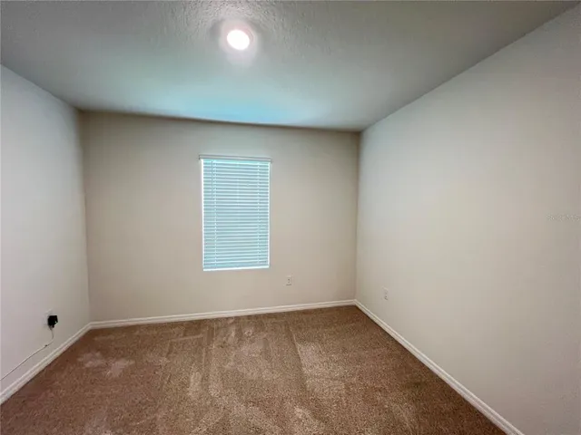 an empty room with closet area
