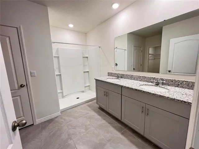 a white toilet sitting next to a small window