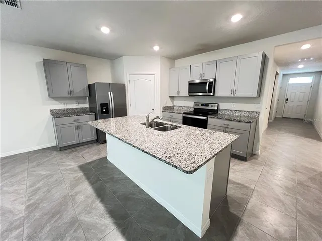 a view of a kitchen with refrigerator and microwave