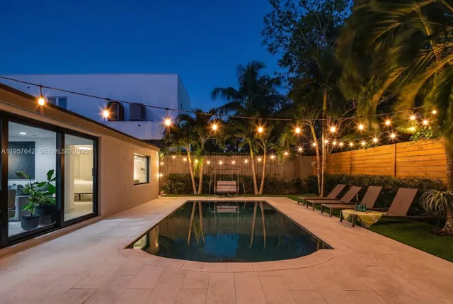 a view of a patio with swimming pool table and chairs