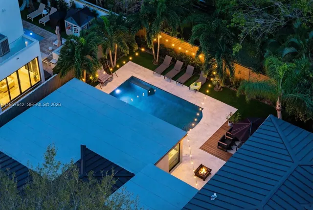 an aerial view of a houses with a yard