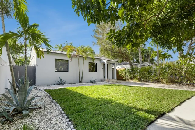 a front view of house with yard and trees