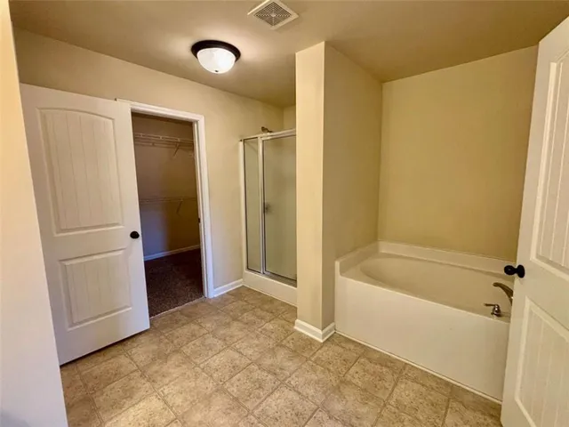 a bathroom with a tub and shower