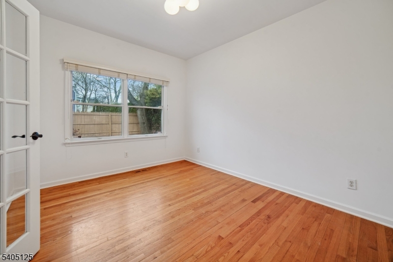 17 Grove Street Summit, NJ 07901 - Photo 16 of 42 a view of an empty room with wooden floor and a window