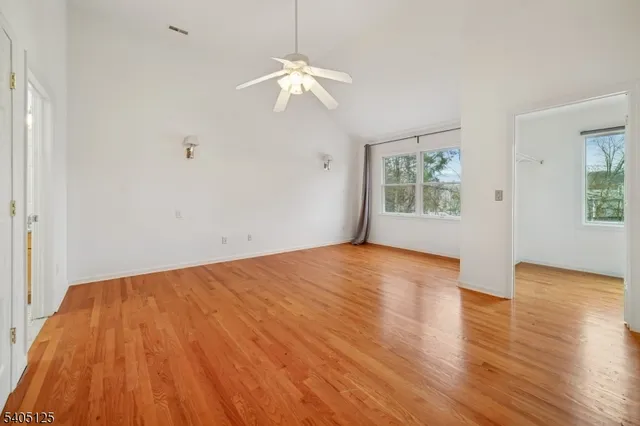 a view of empty room with wooden floor