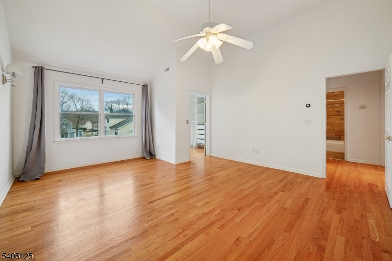 17 Grove Street Summit, NJ 07901 - Photo 18 of 42 an empty room with wooden floor chandelier fan and windows