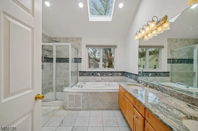 a large bathroom with a tub a sink and mirror