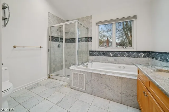 a spacious bathroom with a tub sink and mirror
